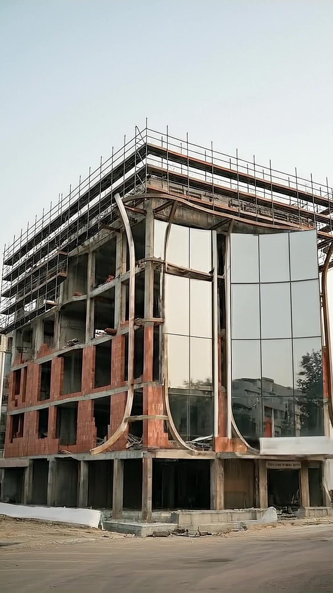Construction — Curved Glass Facade Taking Shape